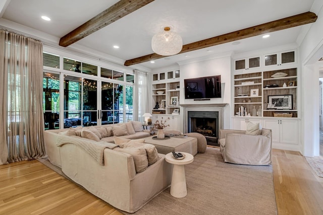 living room featuring built in shelves and light hardwood / wood-style flooring