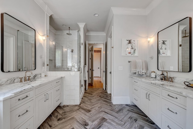 bathroom featuring parquet flooring, vanity, a shower with door, and ornamental molding