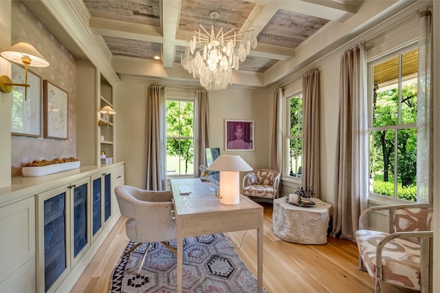 office space with light wood-type flooring, coffered ceiling, crown molding, an inviting chandelier, and beamed ceiling