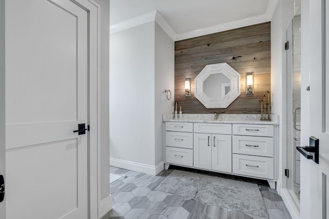 bathroom featuring vanity, wood walls, ornamental molding, and walk in shower