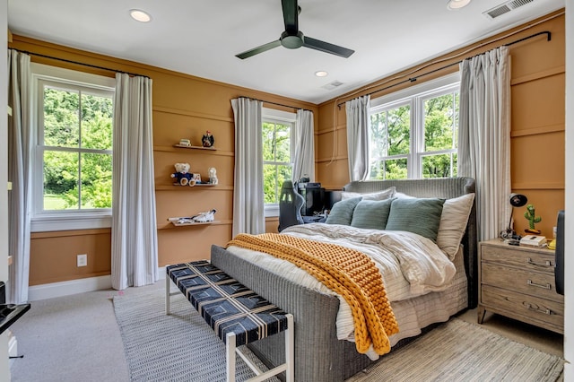 bedroom with ceiling fan and light carpet