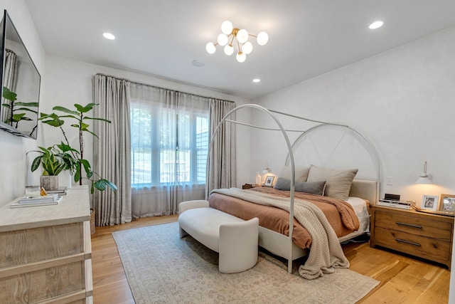 bedroom featuring a notable chandelier and light hardwood / wood-style floors