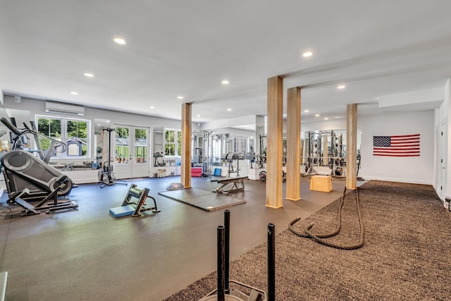 gym featuring a wall unit AC and french doors