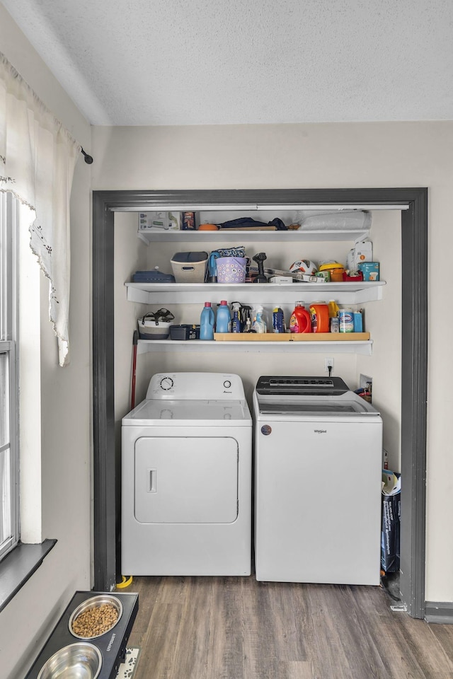 clothes washing area featuring independent washer and dryer, hardwood / wood-style floors, and a textured ceiling