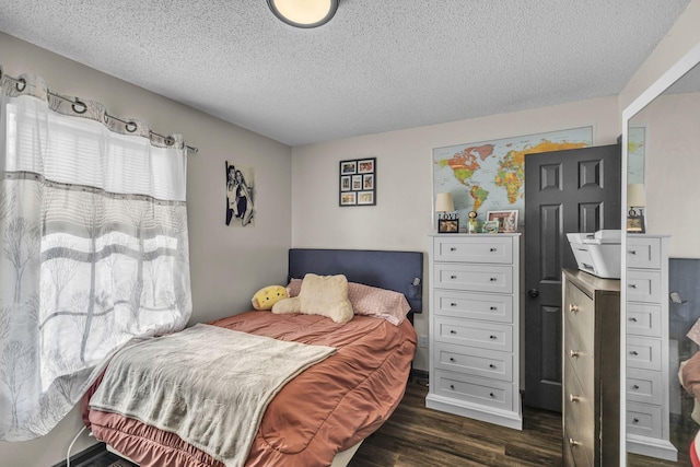 bedroom featuring dark hardwood / wood-style flooring and a textured ceiling