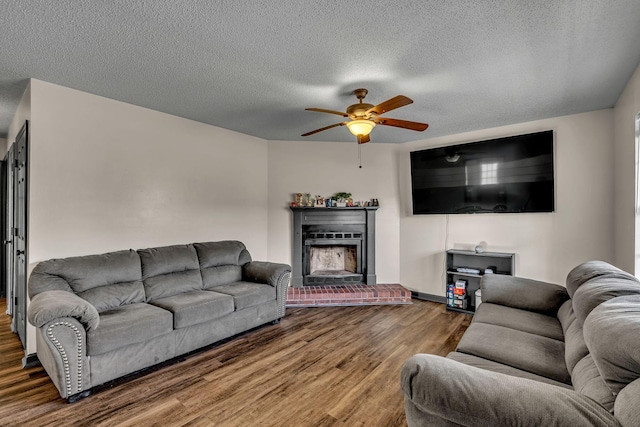 living room featuring hardwood / wood-style floors, a textured ceiling, and ceiling fan