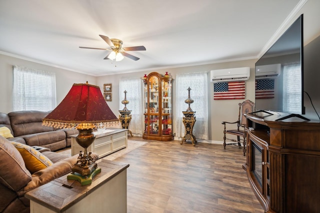 living room featuring plenty of natural light, wood-type flooring, an AC wall unit, and ornamental molding