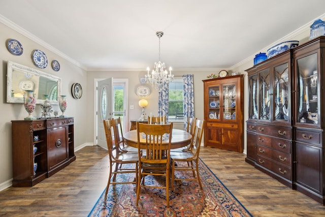 dining room with dark hardwood / wood-style flooring, ornamental molding, and a chandelier