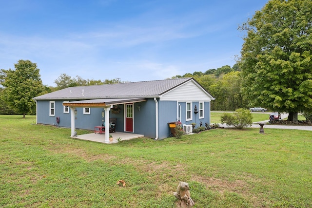 rear view of property featuring a yard and a patio