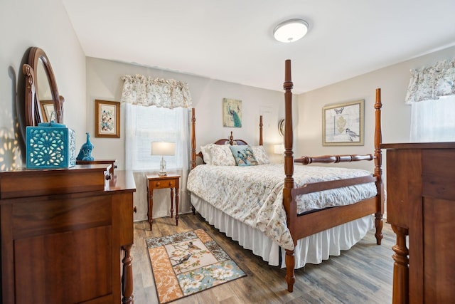 bedroom with dark hardwood / wood-style floors