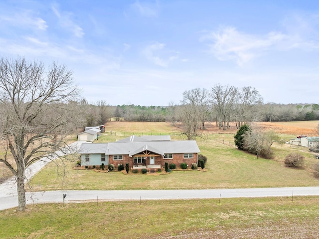 view of front facade featuring a rural view and a front yard