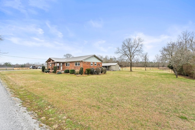 view of yard featuring covered porch and a rural view