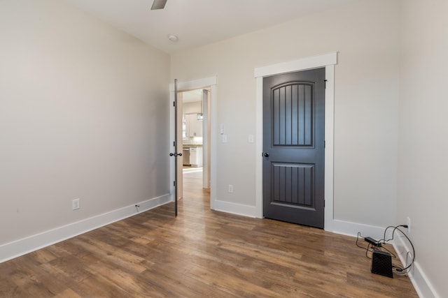 interior space featuring ceiling fan and dark hardwood / wood-style floors