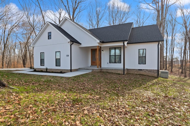 modern inspired farmhouse with central air condition unit and a front yard