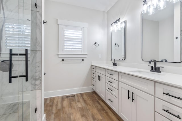 bathroom featuring vanity, wood-type flooring, and walk in shower