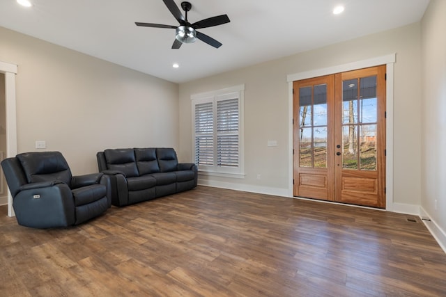 living room featuring french doors, ceiling fan, and dark wood-type flooring