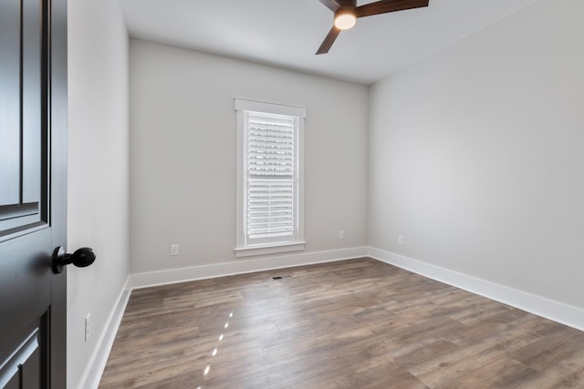 unfurnished room with ceiling fan and wood-type flooring