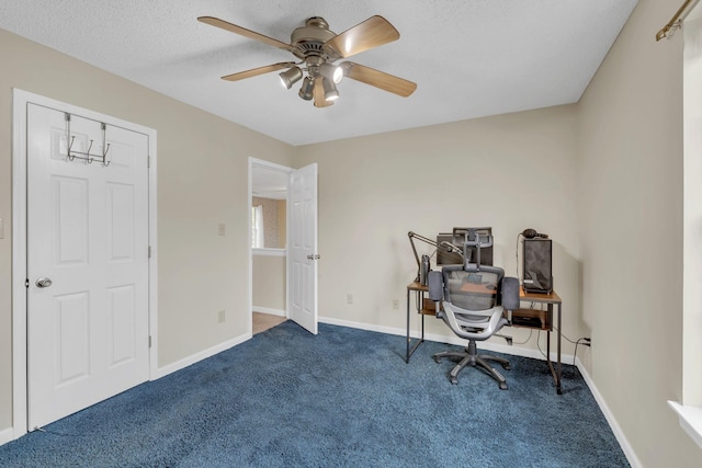 carpeted office featuring ceiling fan and a textured ceiling