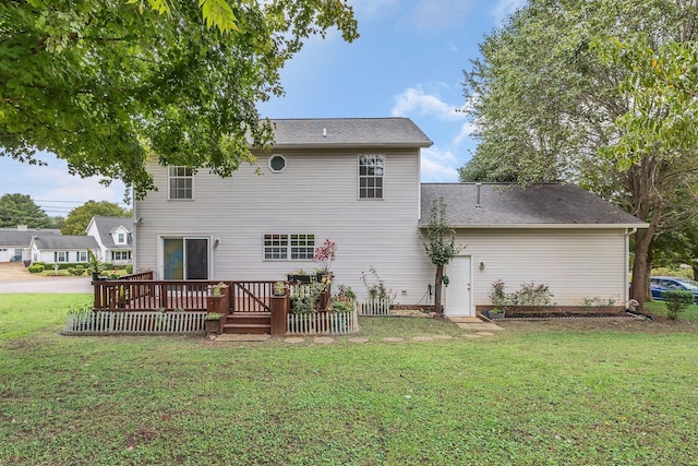 back of property with a lawn and a wooden deck