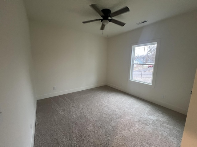 carpeted spare room with ceiling fan