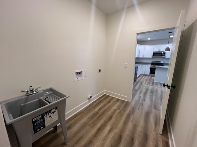 laundry area featuring hookup for a washing machine, hardwood / wood-style floors, and hookup for an electric dryer