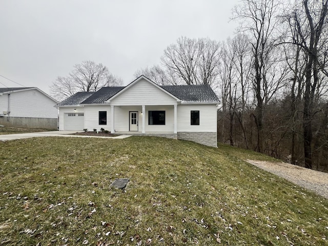 modern inspired farmhouse featuring a front yard, a porch, and a garage