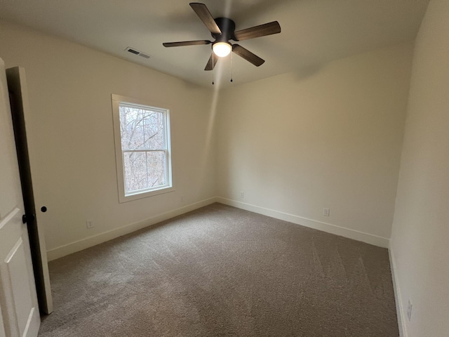 carpeted spare room featuring ceiling fan