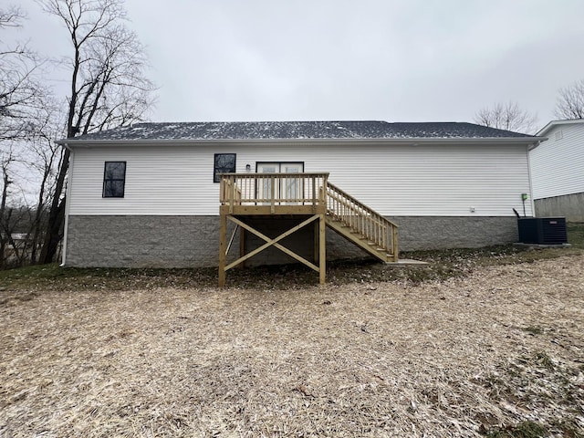 back of property featuring central AC unit and a deck