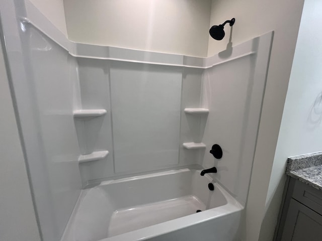 bathroom with bathtub / shower combination and vanity