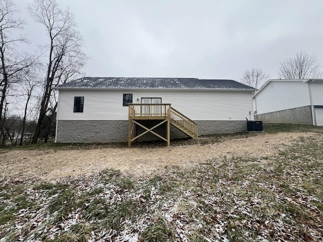 rear view of house featuring cooling unit and a deck