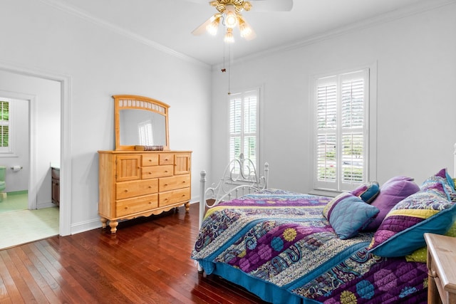 bedroom with connected bathroom, dark hardwood / wood-style floors, ceiling fan, and crown molding