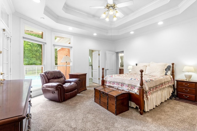 carpeted bedroom featuring multiple windows, a tray ceiling, and ceiling fan