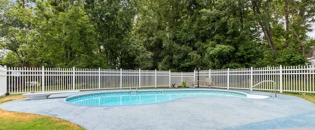 view of pool featuring a diving board