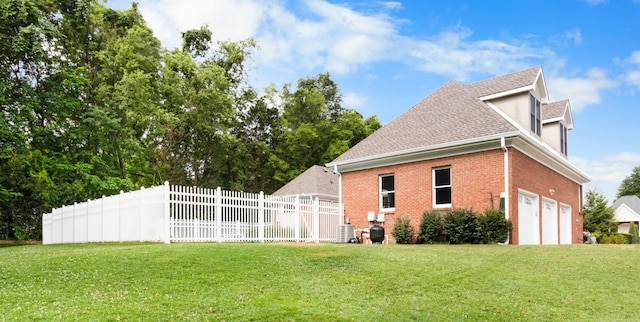 view of property exterior featuring a yard, central AC unit, and a garage