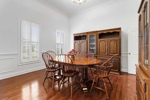 dining area featuring ornamental molding and dark wood-type flooring