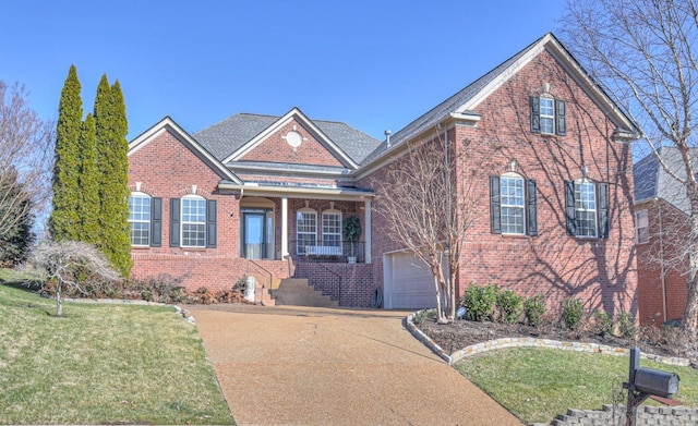 front facade with a front lawn and a garage