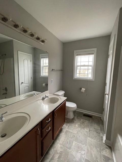 bathroom featuring toilet and vanity