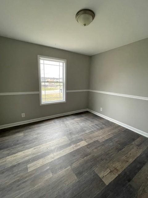 spare room with dark hardwood / wood-style floors