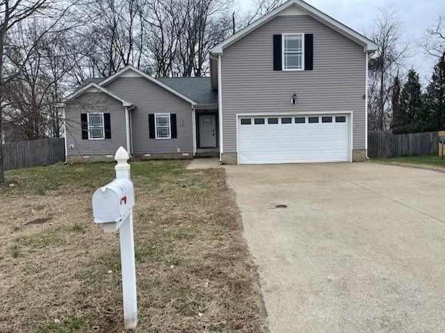 view of front property with a garage and a front yard