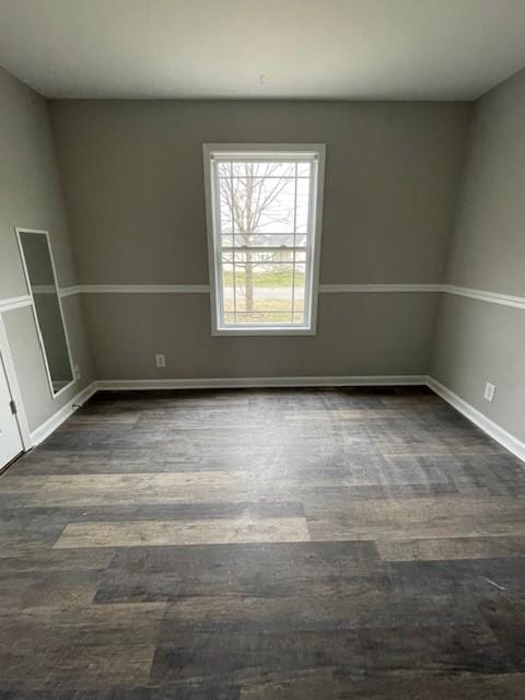 spare room with dark wood-type flooring