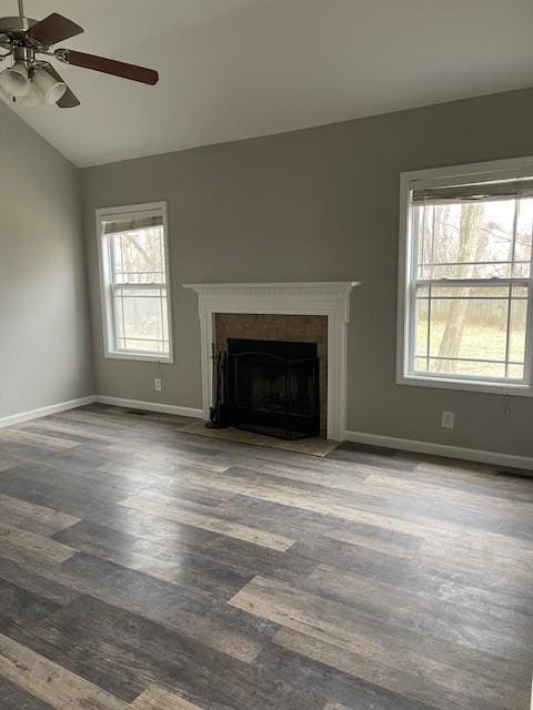 unfurnished living room with ceiling fan, a wealth of natural light, lofted ceiling, and wood-type flooring