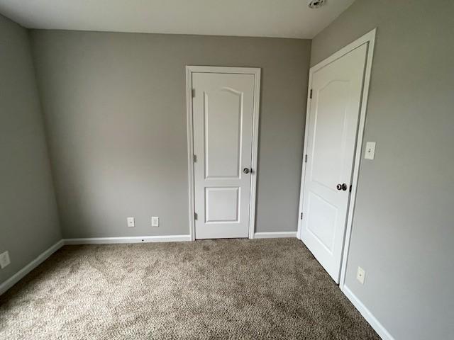 unfurnished bedroom featuring carpet flooring