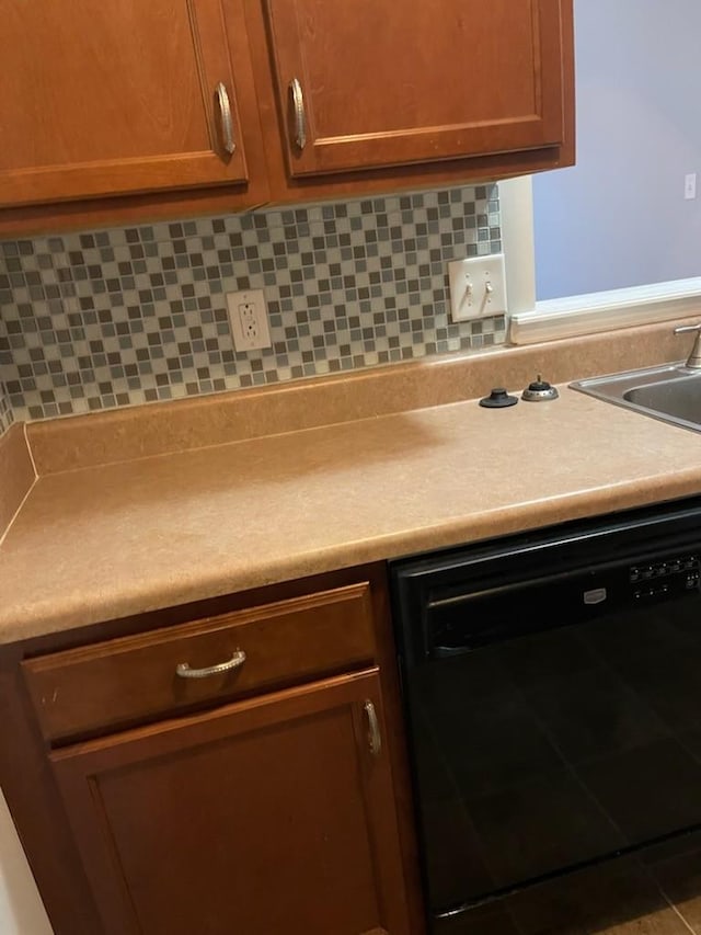 kitchen with dishwasher, tasteful backsplash, and sink