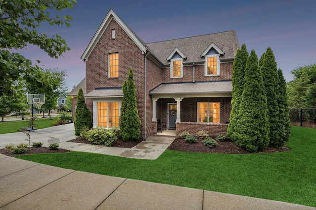 view of front of house featuring a lawn and a porch