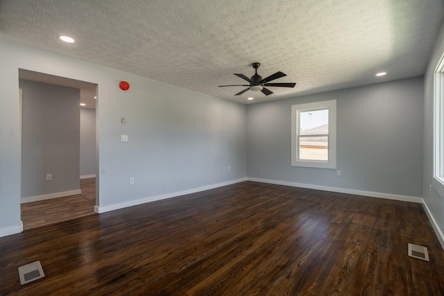 unfurnished room with a textured ceiling, dark hardwood / wood-style floors, and ceiling fan