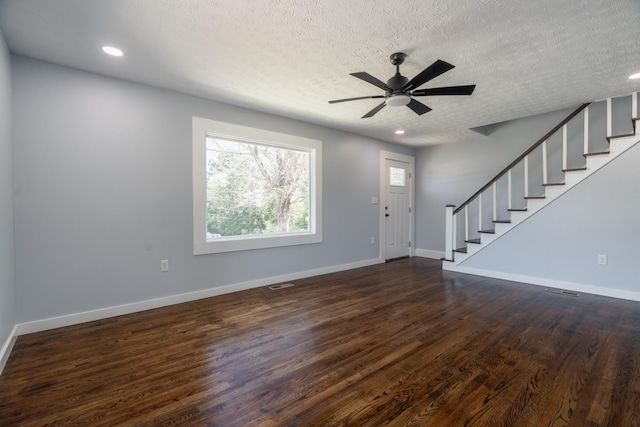 entrance foyer featuring a textured ceiling, ceiling fan, and dark wood-type flooring