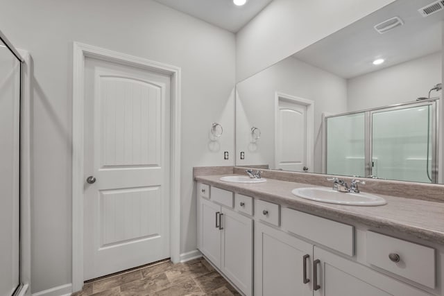 bathroom with vanity and an enclosed shower