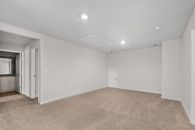 unfurnished room featuring light carpet