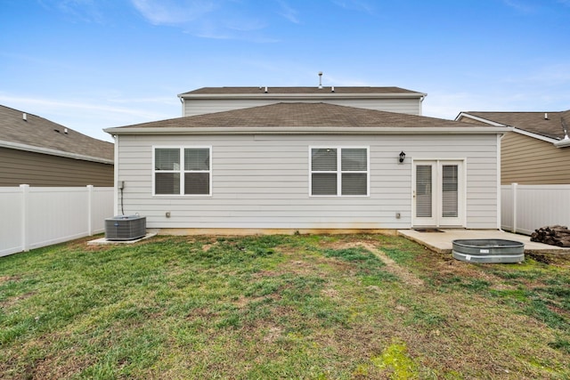 back of property featuring a lawn, a patio area, and central air condition unit