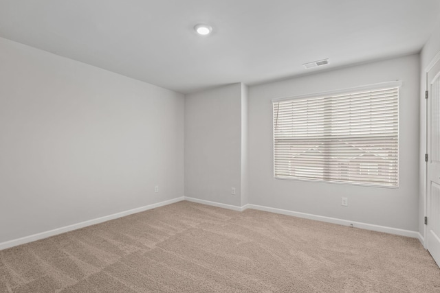 empty room featuring light carpet